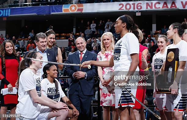 Breanna Stewart and Moriah Jefferson of the Connecticut Huskies are honored by teammate Morgan Tuck of the Connecticut Huskies as head coach Geno...