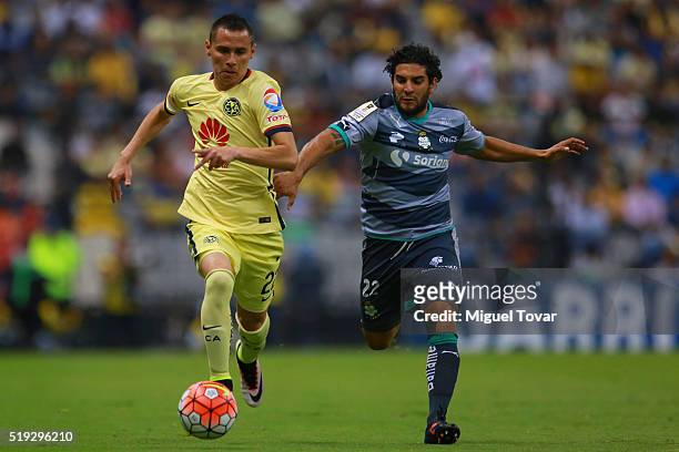 Paul Aguilar of America fights for the ball with Martin Bravo of Santos during the semifinals second leg match between America and Santos Laguna as...