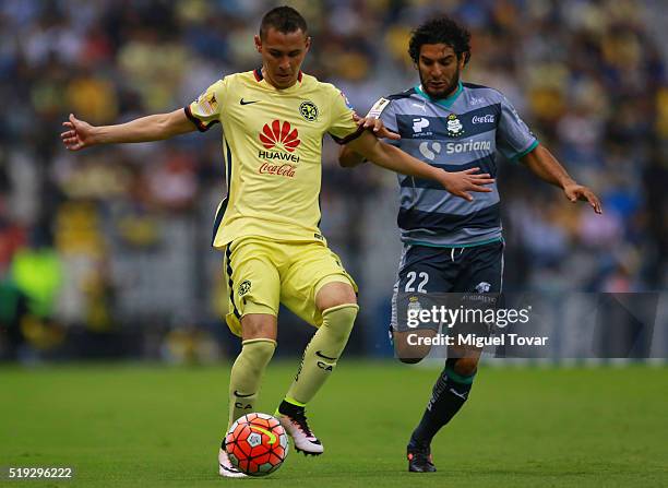 Paul Aguilar of America fights for the ball with Martin Bravo of Santos during the semifinals second leg match between America and Santos Laguna as...