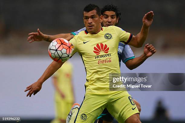 Miguel Samudio of America fights for the ball with Martin Bravo of Santos during the semifinals second leg match between America and Santos Laguna as...