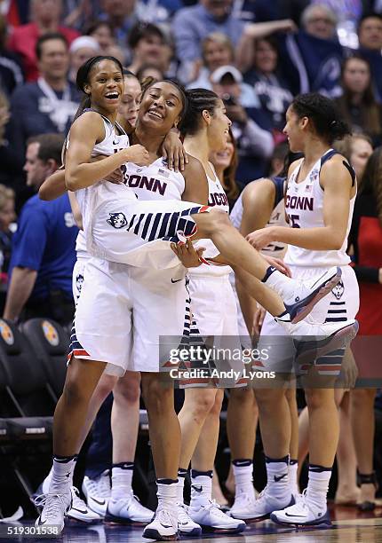 Morgan Tuck and Moriah Jefferson of the Connecticut Huskies embrace as they take the bench in the fourth quarter against the Syracuse Orange during...