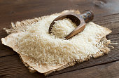 Pile of raw Basmati rice with a spoon