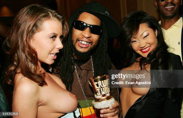 Hip-hop artist Lil Jon poses with adult film stars as they arrive at the 2005 AVN Awards on January 8, 2005 at the Venetian Hotel in Las Vegas,...