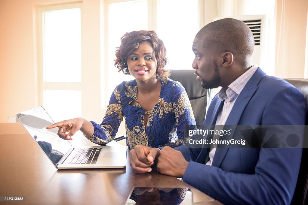 Two African business colleagues meeting in modern office