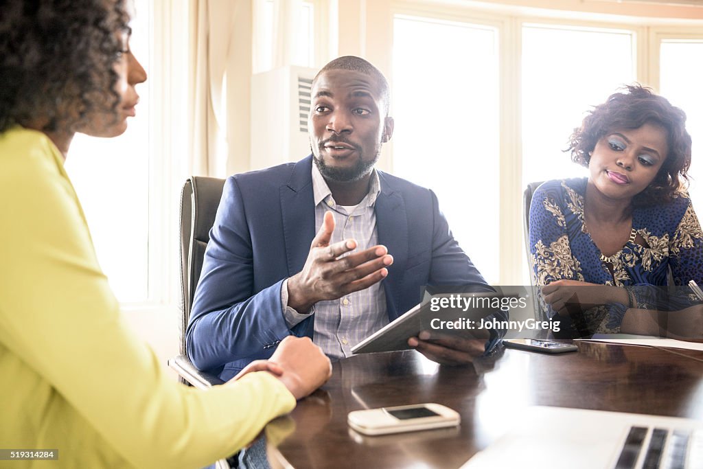 Businessman and two female colleagues in meeting