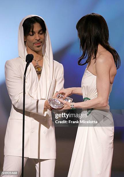 Musician Prince presents the award for "Favorite Leading Lady" to actress Renee Zellweger onstage during the 31st Annual People's Choice Awards at...