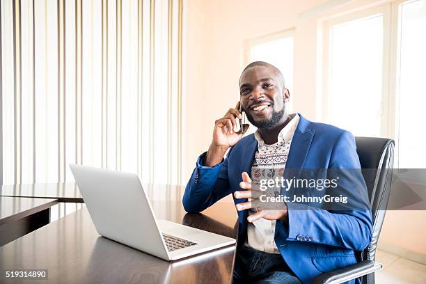 young african businessman on mobile phone in office - nigerian culture stock pictures, royalty-free photos & images