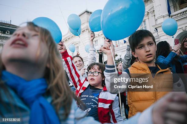 Children launch blue balloons in Celebration Of World Autism Awareness Day on April 2, 2016 in Arad, Romania.