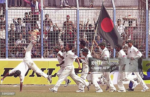 Bangladeshi cricketers celebrate their victory over Zimbabwe at the M. A. Aziz Stadium in Chittagong, 10 January 2005. Bangladesh recorded their...