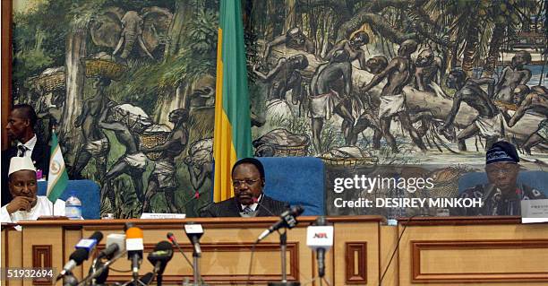 The chairman of the African Union commission Alpha Oumar Konare and Gabonese President Omar Bongo listen to Nigerian President and current chairman...