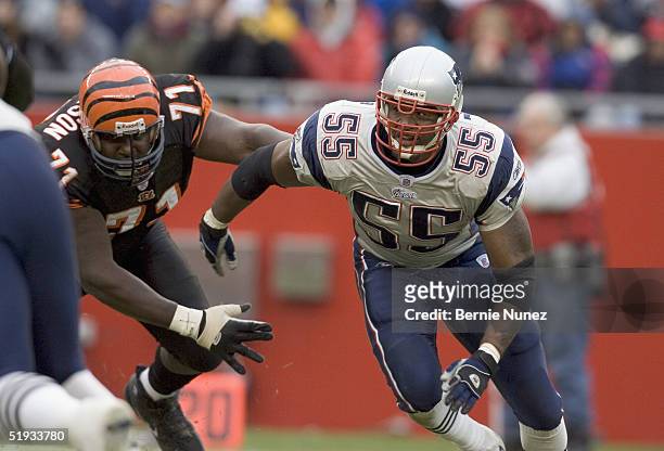 Willie McGinest of the New England Patriots charges past Willie Anderson of the Cincinnati Bengals at Gillette Stadium on December 12, 2004 in...