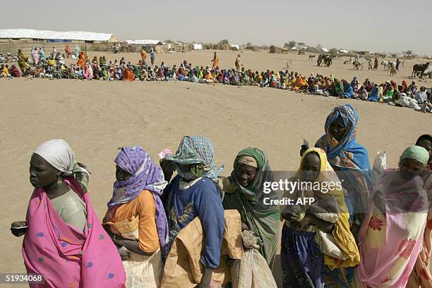 Sudanese displaced people wait to receive food supplies from from the World Food Program distributed by World Vision in Kalma Camp, near Nyala town...