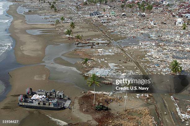 In this U.S. Navy handout photo, a Landing Craft Air Cushion vehicle delivers much needed materials and supplies to the citizens in the city of...