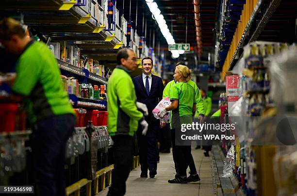 British Chancellor of the Exchequer, George Osborne, chats to members of staff during a visit to the Ocado Customer Fulfilment Centre in Hatfield on...