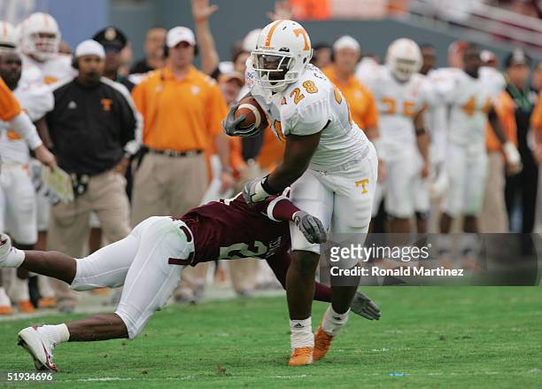 Chris Brown of the Tennessee Volunteers carries the ball against Broderick Newton of the Texas A&M Aggies during the SBC Cotton Bowl game on January...