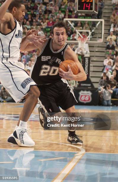 Manu Ginobili of the San Antonio Spurs drives to the basket past Howard Eisley of the Utah Jazz on January 10, 2005 at the Delta Center in Salt Lake...