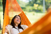 Cheerful girl enjoy in hammock