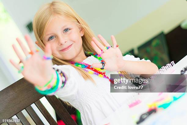 loom bracelets on a young girl's hand - rubber bracelet stock pictures, royalty-free photos & images