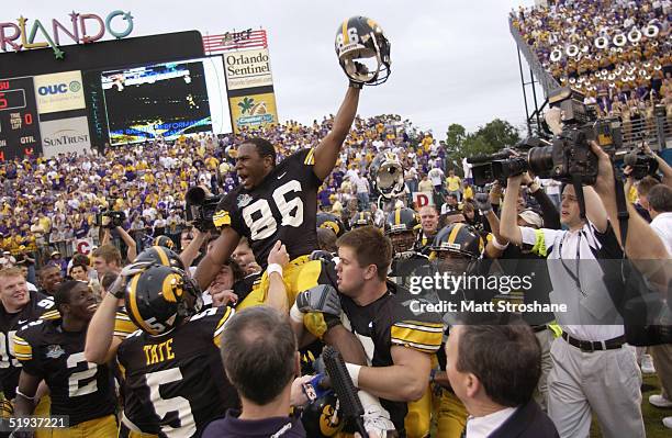 Warren Holloway of the Iowa Hawkeyes is carried on the field by teammates following the Capital One Bowl game against the LSU Tigers at the Florida...