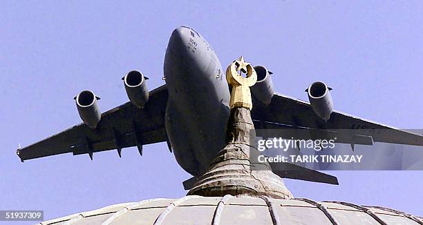 File photo taken in October 2001shows a US airforce C-17 transport plane flying over a mosque during take off from the Incirlik Airbase. The United...