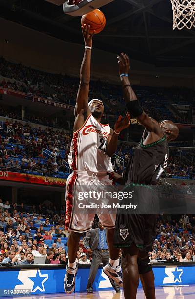 LeBron James of the Cleveland Cavaliers takes the ball to the basket against Kevin Garnett of the Minnesota Timberwolves during the game at Gund...