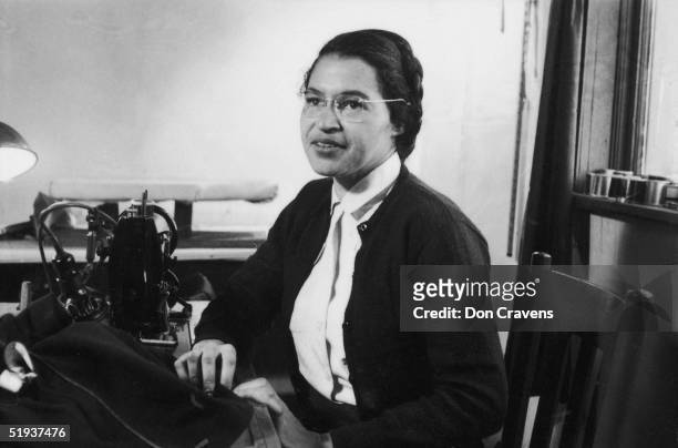 American Civil Rights activist Rosa Parks poses as she works as a seamstress, shortly after the beginning of the Montgomery bus boycott, Montgomery,...