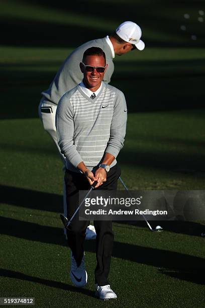 Golf coach Sean Foley looks on as Justin Rose of England hits on the range during a practice round prior to the start of the 2016 Masters Tournament...