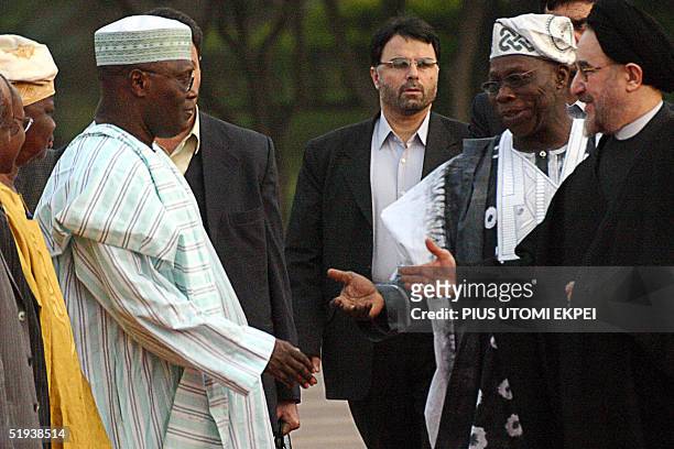 Nigerian President Olusegun Obasanjo introduces Iranian President Mohammed Khatami (r to vice President Atiku Abubakar at the presidential villa in...