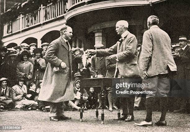 Taylor of Great Britain receives the trophy after winning the British Open Golf Championship by eight strokes at the Royal Liverpool Golf Club in...