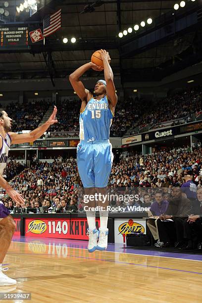 Carmelo Anthony of the Denver Nuggets shoots the ball against Predrag Stojakovic of the Sacramento Kings on January 11, 2005 at Arco Arena in...