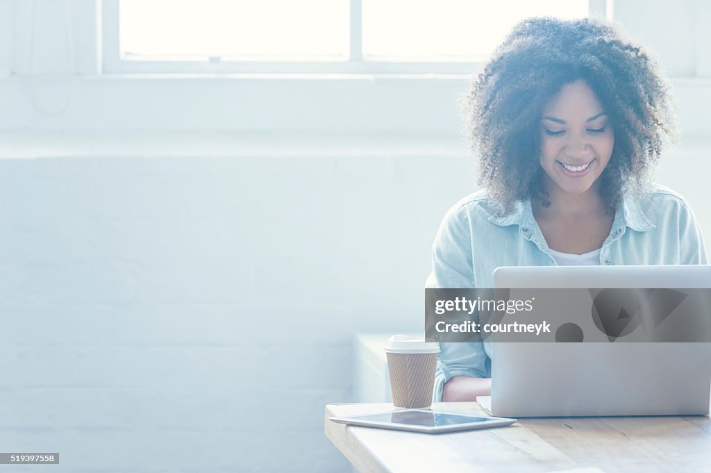 Woman working on a laptop.