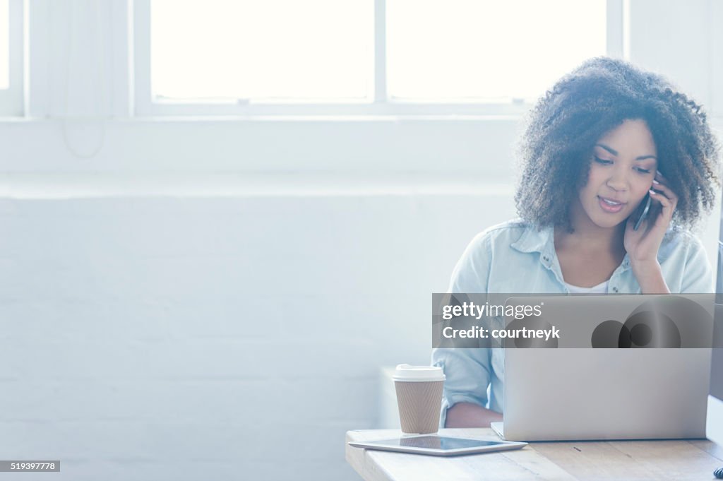 Woman working on a laptop.