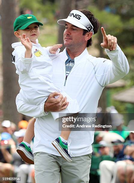 Bubba Watson of the United States carries his son Caleb during the Par 3 Contest prior to the start of the of the 2016 Masters Tournament at Augusta...