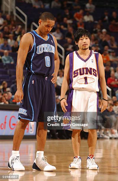 Howard Eisley of the Utah Jazz stands next to Yuta Tabuse of the Phoenix Suns on December 15, 2004 at America West Arena in Phoenix, Arizona. The...