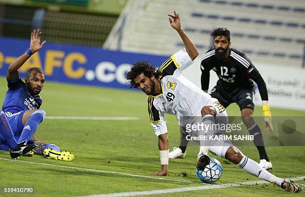 S Al-Nasr club player Khalifa Mubarak Ghanim and Ahmed Shambih defend as Saudi's Al-Ittihad club player Abdulrahman Al-Ghamdi tries to control the...