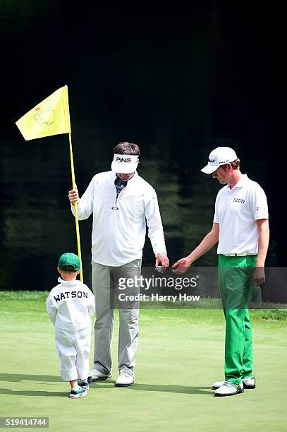 Webb Simpson of the United States talks to Bubba Watson of the United States and his son Caleb during the Par 3 Contest prior to the start of the of...
