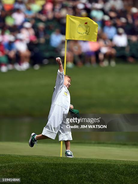 Golfer Bubba Watson's son Caleb plays on the 8th green during the Par 3 contest prior to the start of the 80th Masters of Tournament at the Augusta...
