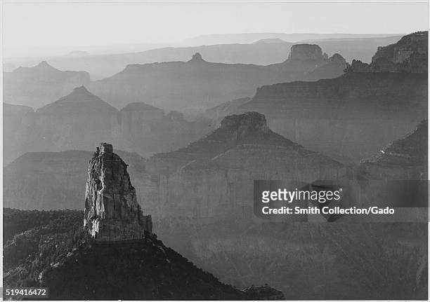 Black and white photograph, view with rock formation in foreground, captioned "Grand Canyon National Park", by Ansel Adams, from Photographs of...