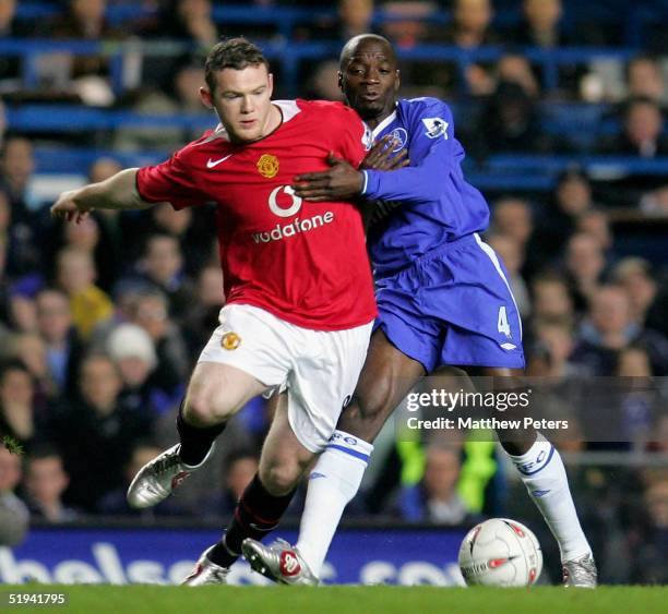 Wayne Rooney of Manchester United clashes with Claude Makelele of Chelsea during the Carling Cup semi-final first leg match between Chelsea and...