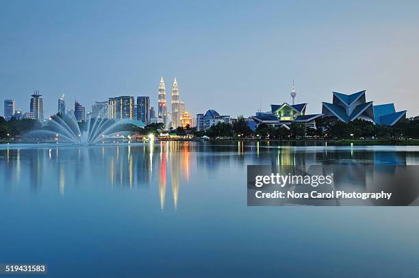 reflection of kuala lumpur night scene - kuala lumpur stock pictures, royalty-free photos & images