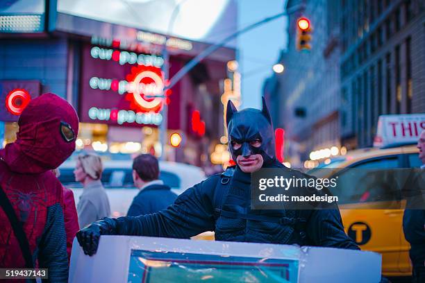 men in batman and spiderman costumes - batman and robin stock pictures, royalty-free photos & images