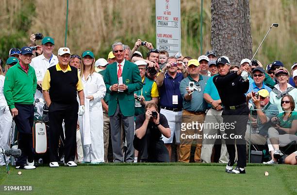 Gary Player hits a hole in one on the seventh hole as Tom Watson of the United States and Jack Nicklaus look on during the Par 3 Contest prior to the...