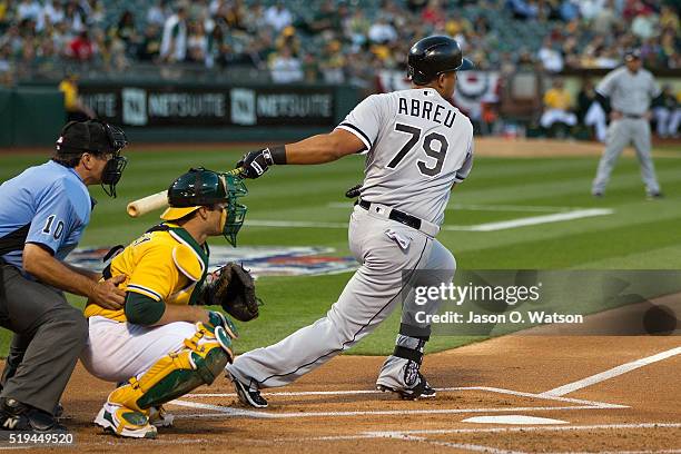 Jose Abreu of the Chicago White Sox at bat in front of Josh Phegley of the Oakland Athletics and umpire Phil Cuzzi during the first inning at the...