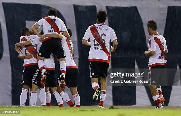 Andres Dalessandro of River Plate celebrates with teammates after scoring the opening goal during a match between River Plate and The Strongest as...