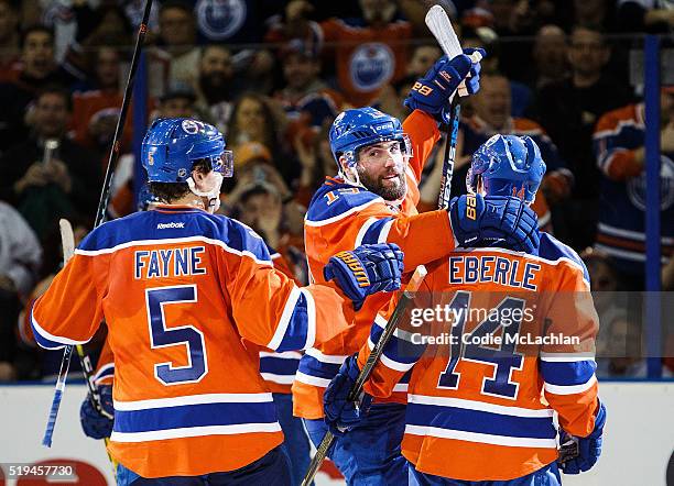 Mark Fayne, Patrick Maroon and Jordan Eberle of the Edmonton Oilers celebrate a goal against the Vancouver Canucks on April 6, 2016 at Rexall Place...