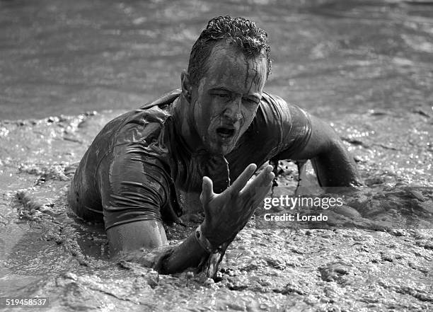 male participant covered in mud at outdoor mud run event - people covered in mud stock pictures, royalty-free photos & images