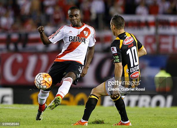 Eder Alvarez Balanta of River Plate fights for the ball with Pablo Escobar of The Strongest during a match between River Plate and The Strongest as...