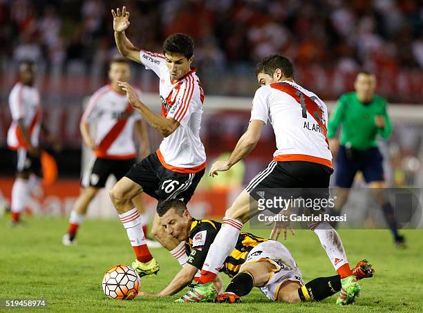 Lucas Alario and Ignacio Fernandez of River Plate fight for the ball with Pablo Escobar of The Strongest during a match between River Plate and The...