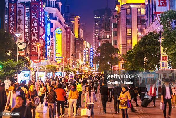 busy shoppping street in shanghai, china at night - shanghai stock pictures, royalty-free photos & images