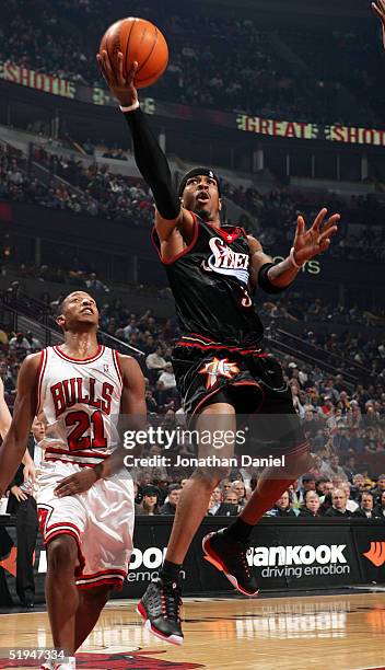Allen Iverson of the Philadelphia 76ers drives to the basket past Chris Duhon of the Chicago Bulls on January 12, 2005 at the United Center in...